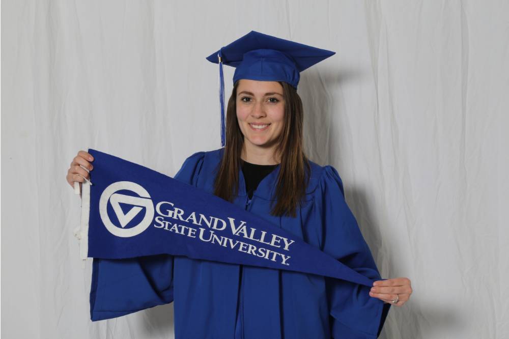 girl poses with blue banner and lettering